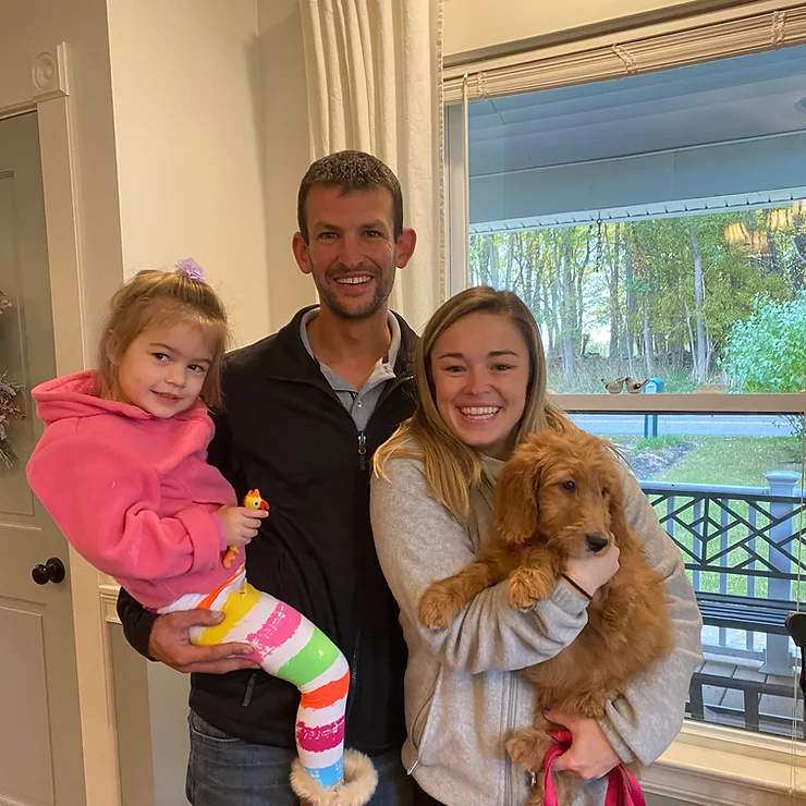 Happy family with their new goldendoodle puppy from NY Dandy Doodles.
